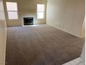 Spacious living room featuring a white fireplace, carpeted floors, and abundant natural light at 1249 Lucia Dr, Las Vegas, NV 89128