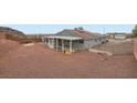 A large backyard, featuring low maintenance landscaping and a covered patio at 127 Mauve St, Henderson, NV 89012
