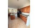 A kitchen with an island, dark cabinets and countertops and stainless steel appliances at 16 Goldleaf Falls Ave, North Las Vegas, NV 89031