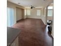 Open-plan living room with wood floors and large windows at 16 Goldleaf Falls Ave, North Las Vegas, NV 89031