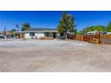 Quaint single-story home with a covered carport and a fenced yard, offering privacy and charm at 208 W Alma St, Overton, NV 89040