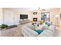 A bright living room showcasing a fireplace, television, and a comfortable seating area at 2451 N Rainbow Blvd # 2131, Las Vegas, NV 89108