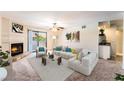 Bright living room featuring a fireplace, ceiling fan, and a sliding glass door to a balcony at 2451 N Rainbow Blvd # 2131, Las Vegas, NV 89108