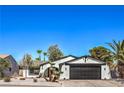 Charming single-story home features desert landscaping, a black garage door, and a well-maintained front yard at 2529 Indian Sage Way, Las Vegas, NV 89108