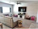 Open-concept living room with carpet, decor, a television, and natural light from the window at 2585 Amazing Meadows Ave # 1007, North Las Vegas, NV 89031