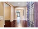 Spacious foyer with gleaming hardwood floors, elegant chandelier, and an arched doorway at 2601 Bechamel Pl, Henderson, NV 89044