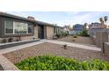 Well-kept front yard featuring drought-resistant landscaping and a charming garden wall at 4009 Patterson Ave, Las Vegas, NV 89104