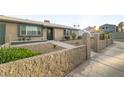 Beautiful home exterior featuring a stone garden wall and drought resistant landscaping at 4009 Patterson Ave, Las Vegas, NV 89104