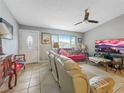 Comfortable living room with tile floors, ceiling fan, and bright natural light at 4009 Patterson Ave, Las Vegas, NV 89104