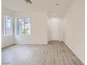 Bright, airy living room featuring wood-look flooring, ample natural light, and a clean, neutral color scheme at 4045 Oliver Sagebrush Dr, Las Vegas, NV 89122