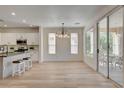 Bright, open kitchen with white cabinetry, stainless steel appliances, and a center island with seating at 4379 Bella Cascada St, Las Vegas, NV 89135