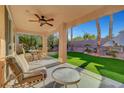 Inviting covered patio with ceiling fan, ideal for relaxing and entertaining outdoors at 4379 Bella Cascada St, Las Vegas, NV 89135