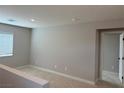 Neutral-toned bedroom with plush carpet, a window with blinds, and an ensuite bathroom at 4405 Pioche Ave, North Las Vegas, NV 89032