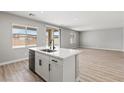 Kitchen island with marble countertop, stainless steel sink, and views into the spacious living area at 4405 Pioche Ave, North Las Vegas, NV 89032