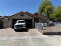 Cozy single-story home with an attached garage and gated front yard at 4923 Arizona Ave, Las Vegas, NV 89104