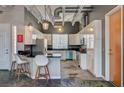 Modern kitchen features sleek white cabinets, stainless steel appliances, and bar seating for casual dining at 5096 Thunder River Cir, Las Vegas, NV 89148