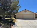 Beautiful one-story house boasting a spacious two-car garage, nice landscaping, and bright curb appeal at 5121 Burr Oak Dr, Las Vegas, NV 89130