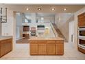 Kitchen island overlooking a large living room area with a fireplace and staircase at 5405 Ireland St, Las Vegas, NV 89149