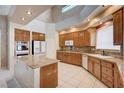 Well lit kitchen featuring an island, tile floors, granite countertops, and stainless steel appliances at 5405 Ireland St, Las Vegas, NV 89149