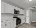 Modern kitchen features white cabinets, stainless steel appliances, and beautiful countertops at 6437 Burgundy Way, Las Vegas, NV 89107