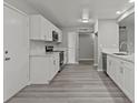 Modern kitchen with white cabinets, stainless steel appliances, and quartz countertops at 6437 Burgundy Way, Las Vegas, NV 89107