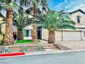Charming two-story home featuring palm trees and a well-maintained landscaped front yard at 7109 Rancho De Taos, Las Vegas, NV 89130