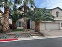 Two-story home with a three car garage, manicured landscaping, and mature palm trees at 7109 Rancho De Taos, Las Vegas, NV 89130