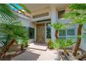 Inviting home entrance framed by lush landscaping and featuring a contemporary double-door design at 72 Innisbrook Ave, Las Vegas, NV 89113