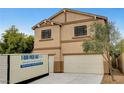 Two-story home with a two-car garage and neutral paint scheme, plus a portable storage container on the driveway at 9017 Wolf Dancer Ave, Las Vegas, NV 89143