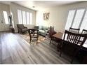 Bright living room with hardwood floors, large windows, and comfortable seating at 10071 Lemon Valley Ave, Las Vegas, NV 89147