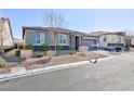 Charming single-story home featuring manicured landscaping, stone accents, shutters, and a two-car garage at 10095 Ferton Lake Ave, Las Vegas, NV 89178