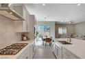 Open-concept kitchen flows seamlessly into the dining and living areas, creating a perfect space for entertaining at 10251 Tiger Milkweed St, Las Vegas, NV 89141
