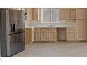 Bright kitchen features wood cabinets, stainless steel appliances, and laminate floors at 10809 Clarion Ln, Las Vegas, NV 89134
