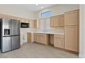 Bright kitchen features wood cabinets, stainless steel appliances, and laminate floors at 10809 Clarion Ln, Las Vegas, NV 89134
