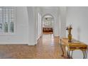 Bright hallway featuring elegant arches, custom flooring, and views to the front and back of the home at 11369 Rancho Villa Verde Pl, Las Vegas, NV 89138