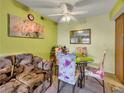 Bright dining area with a glass table and decorative chairs near the living room sofa at 1455 E Katie Ave # K14, Las Vegas, NV 89119