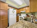 Well-equipped kitchen featuring granite countertops, a white refrigerator, and modern appliances at 1455 E Katie Ave # K14, Las Vegas, NV 89119