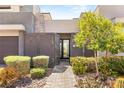 Inviting front entrance with gated courtyard and desert landscaping, offering privacy and charm at 15 Gemstar Ln, Las Vegas, NV 89135