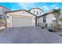 Two-story home with brick driveway, a two-car garage, and desert landscaping at 19 Cresta Villa Ct, Henderson, NV 89011