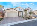 Two-story home featuring a brick driveway, a two-car garage, and desert landscaping at 19 Cresta Villa Ct, Henderson, NV 89011