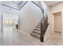 Bright, open foyer with tile flooring, stairs, and views into the adjacent rooms at 19 Cresta Villa Ct, Henderson, NV 89011