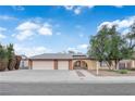 Charming single-story home featuring a two-car garage, an arched entryway and mature landscaping at 1913 Piccolo Way, Las Vegas, NV 89146