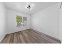 Bright bedroom with stylish wood-look floors and a modern ceiling light fixture at 2208 Spring Water Dr, Las Vegas, NV 89134