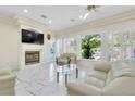 Cozy living room boasting large windows, fireplace, and marble floors at 2209 Glenbrook Way, Las Vegas, NV 89117