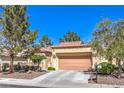 Inviting single-story house with desert landscaping, a tile roof, and two car garage at 2330 Spring Water Dr, Las Vegas, NV 89134