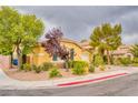 Cozy single-story home with a well-manicured front yard featuring mature trees at 2383 Rainswept Ave, Henderson, NV 89052