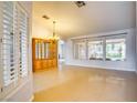Bright living room boasting tile flooring, large windows, and chandelier at 2383 Rainswept Ave, Henderson, NV 89052