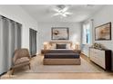 This bedroom features a neutral color palette, a ceiling fan, and two bedside tables with lamps for a serene retreat at 2409 Cockatiel Dr, North Las Vegas, NV 89084
