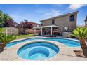 Beautiful backyard oasis featuring a custom pool and spa with mature landscaping and spacious patio at 248 Hyssop Ct, Henderson, NV 89015
