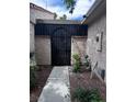 View of gated entry featuring mature landscaping at 2484 Domingo St, Las Vegas, NV 89121